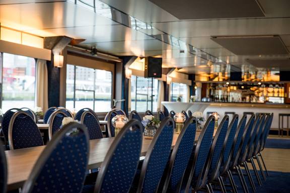 Lange vergadertafel met blauwe stoelen in de salon van de Smaragd 2