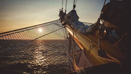 Zonsondergang gezien vanaf de boeg van een traditioneel zeilschip