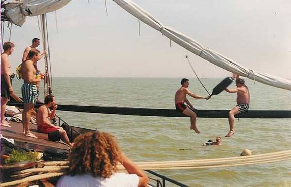 Gasten houden een kussengevecht op de giek van de Vrouwe Jitske