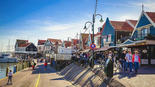 Wandelaars op de dijk langs de haven van Volendam